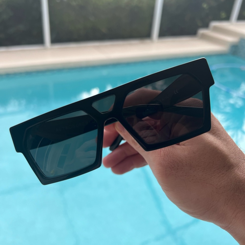 Retrosuperfuture amazing, futuristic shaped black sunglasses.